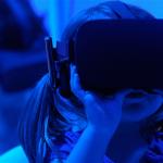 Girl looking through virtual reality tool.